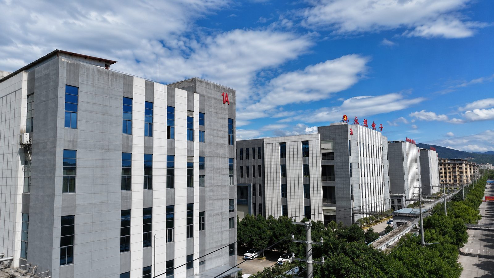Yongzhao Electronics PCB factory buildings with rooftop company signage, Suichuan, Jiangxi, China